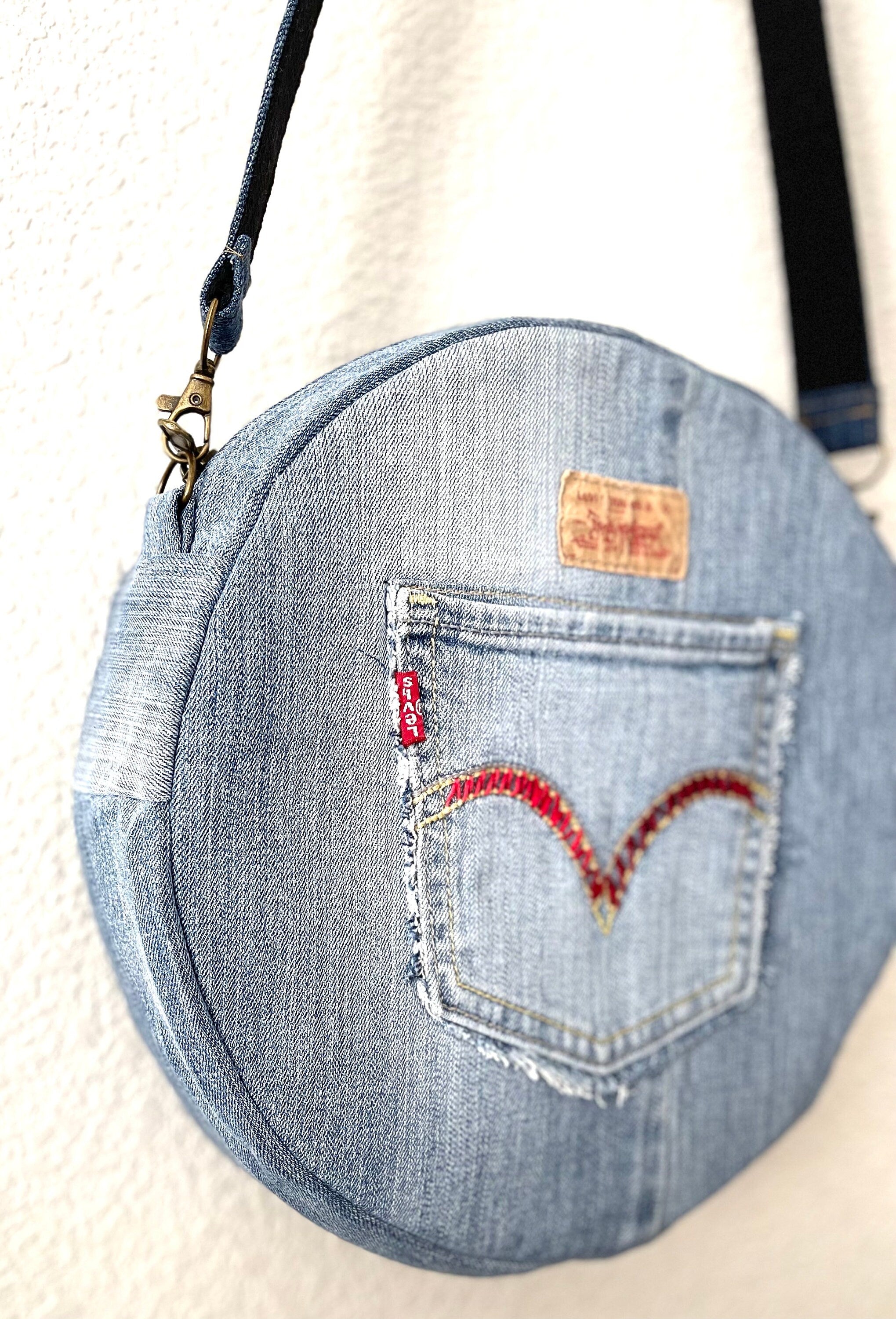 Upcycled denim jeans boho Round Crossbody bag with zipper and pockets.