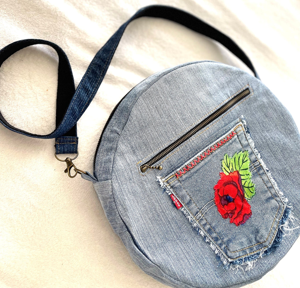 Upcycled denim jeans boho Round Crossbody bag with zipper and pockets.