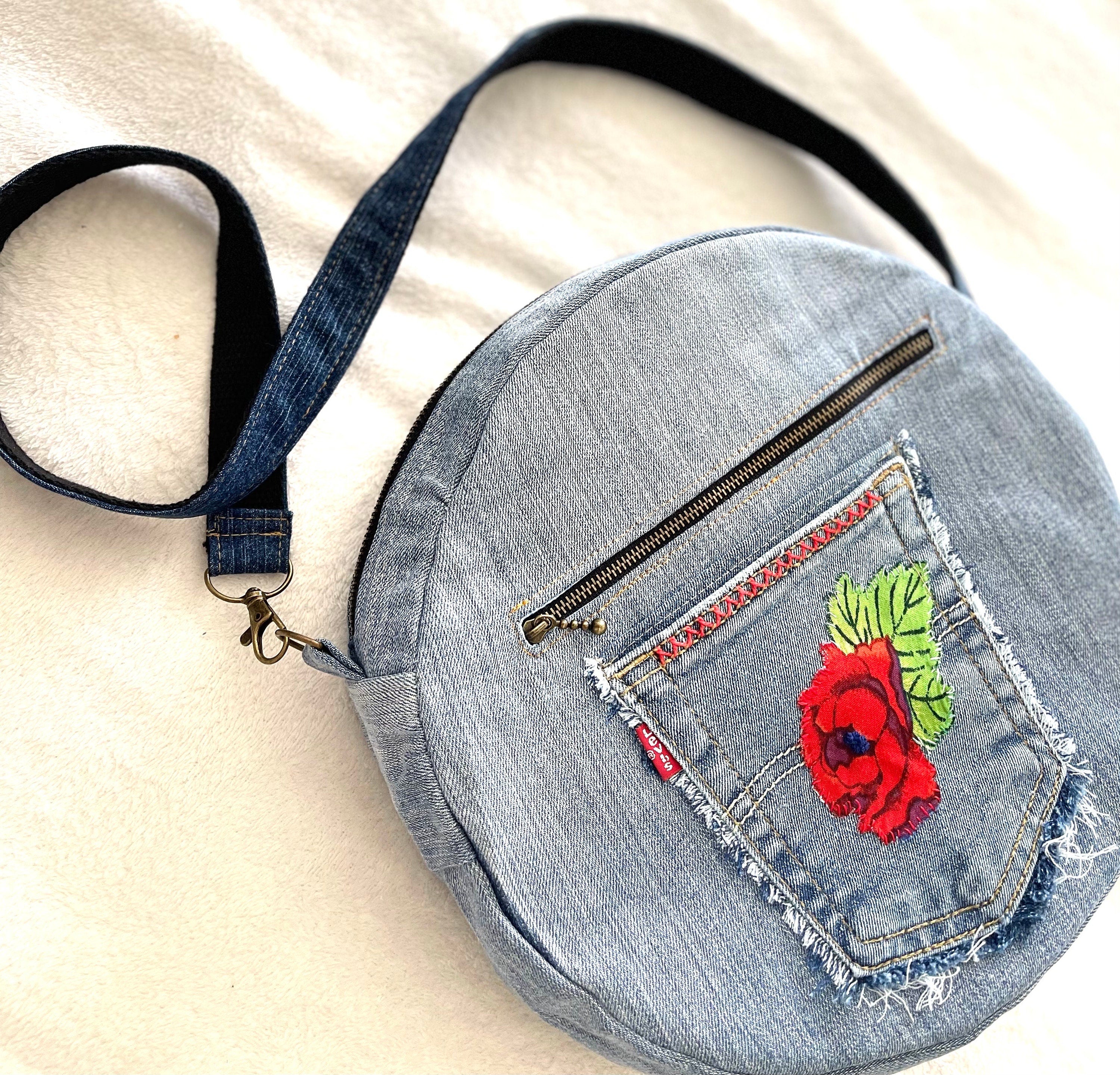 Upcycled denim jeans boho Round Crossbody bag with zipper and pockets.