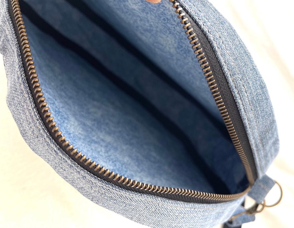Upcycled denim jeans boho Round Crossbody bag with zipper and pockets.