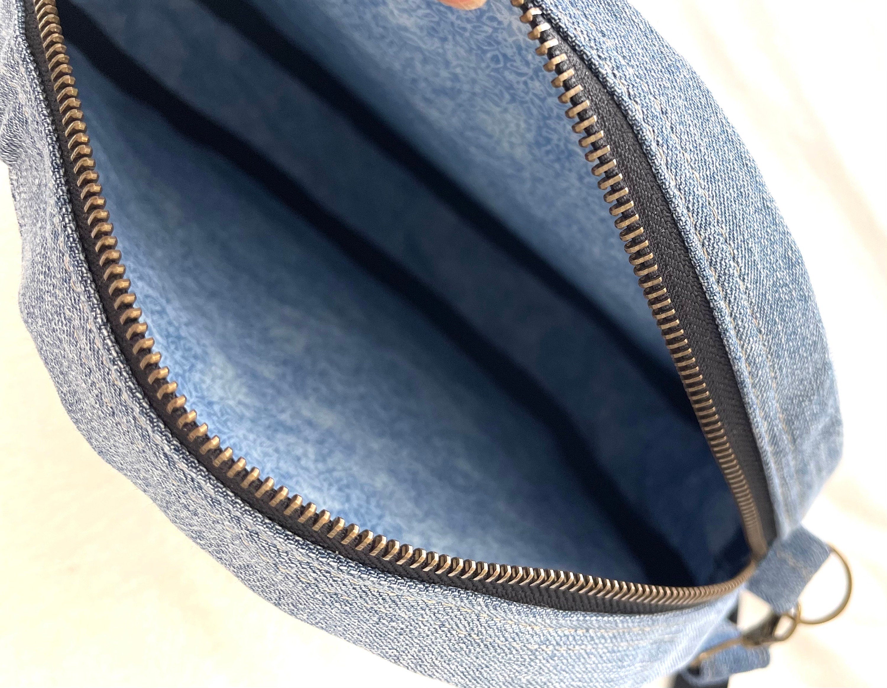 Upcycled denim jeans boho Round Crossbody bag with zipper and pockets.