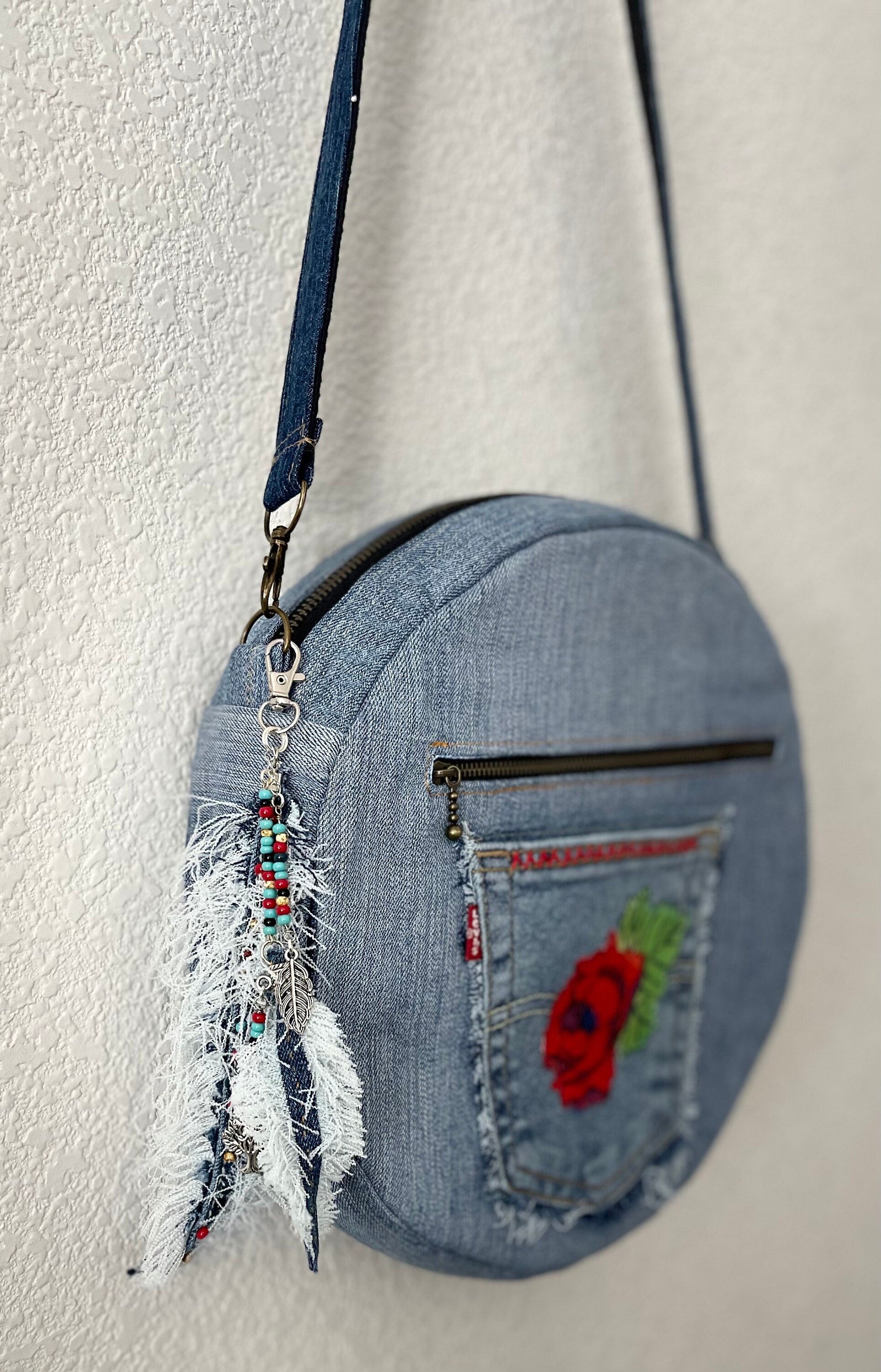 Upcycled denim jeans boho Round Crossbody bag with zipper and pockets.