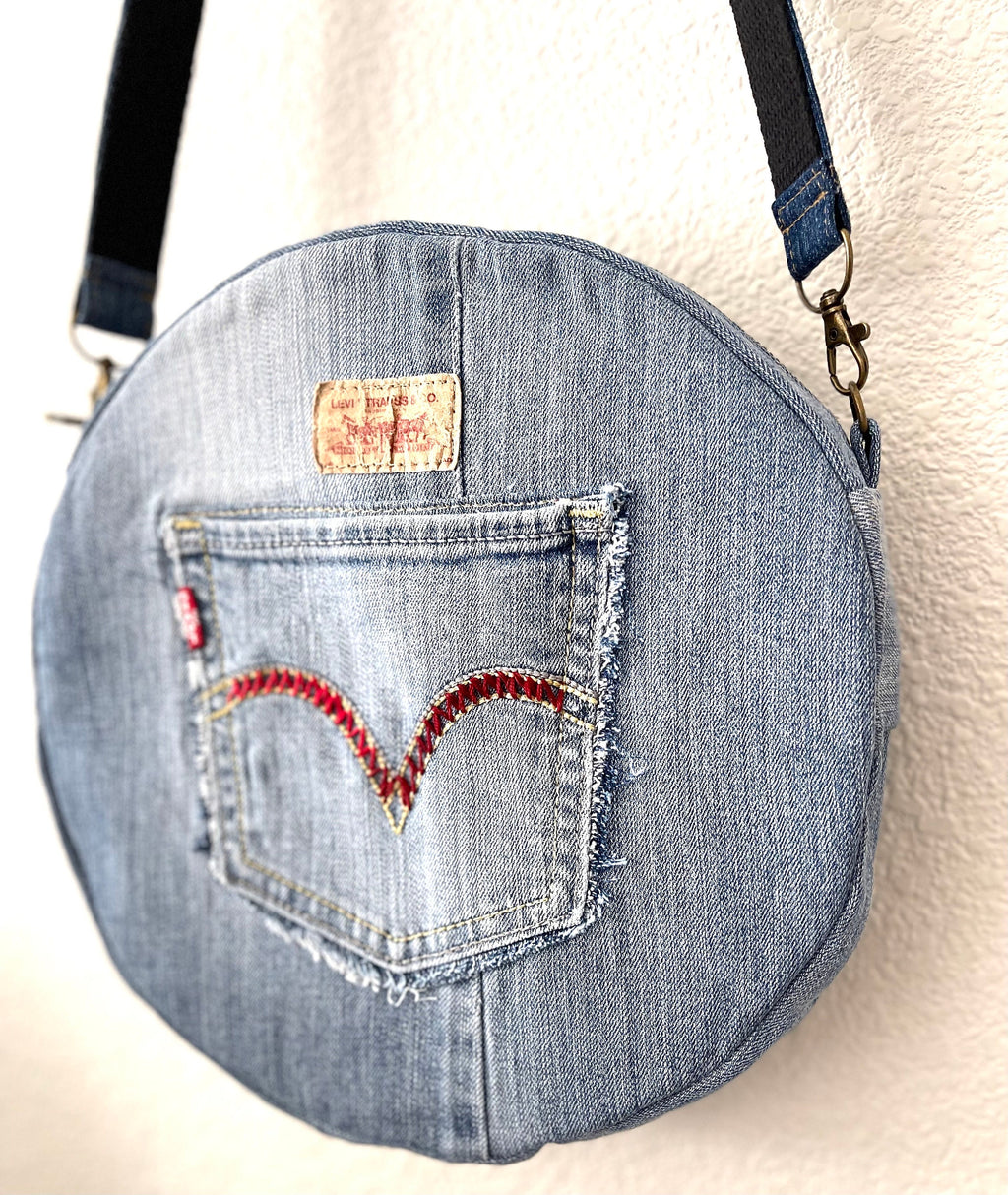 Upcycled denim jeans boho Round Crossbody bag with zipper and pockets.