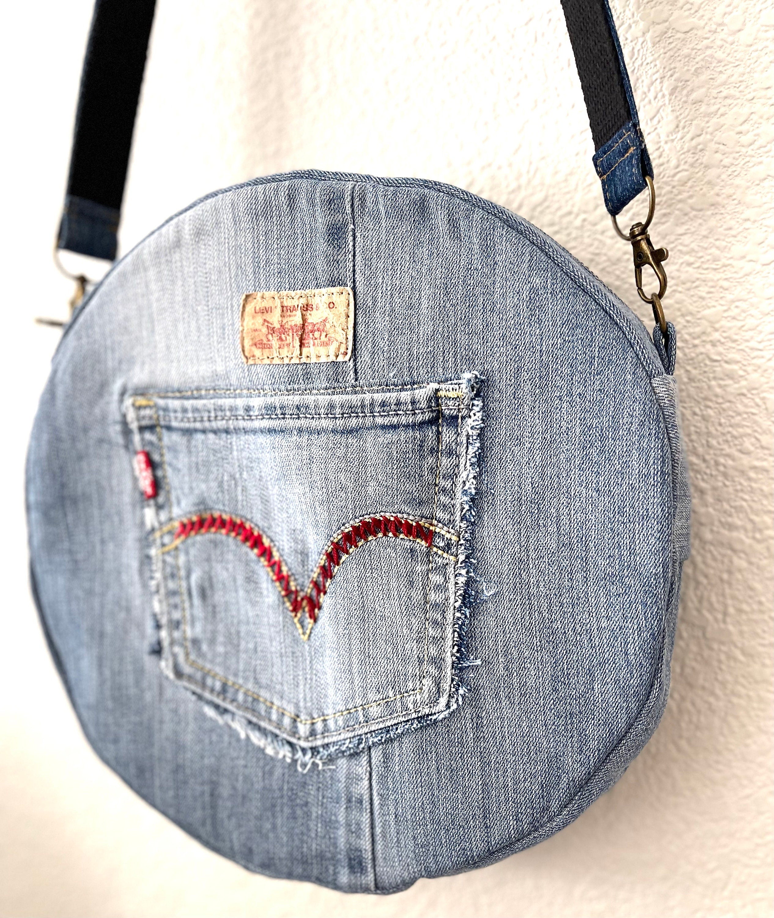 Upcycled denim jeans boho Round Crossbody bag with zipper and pockets.