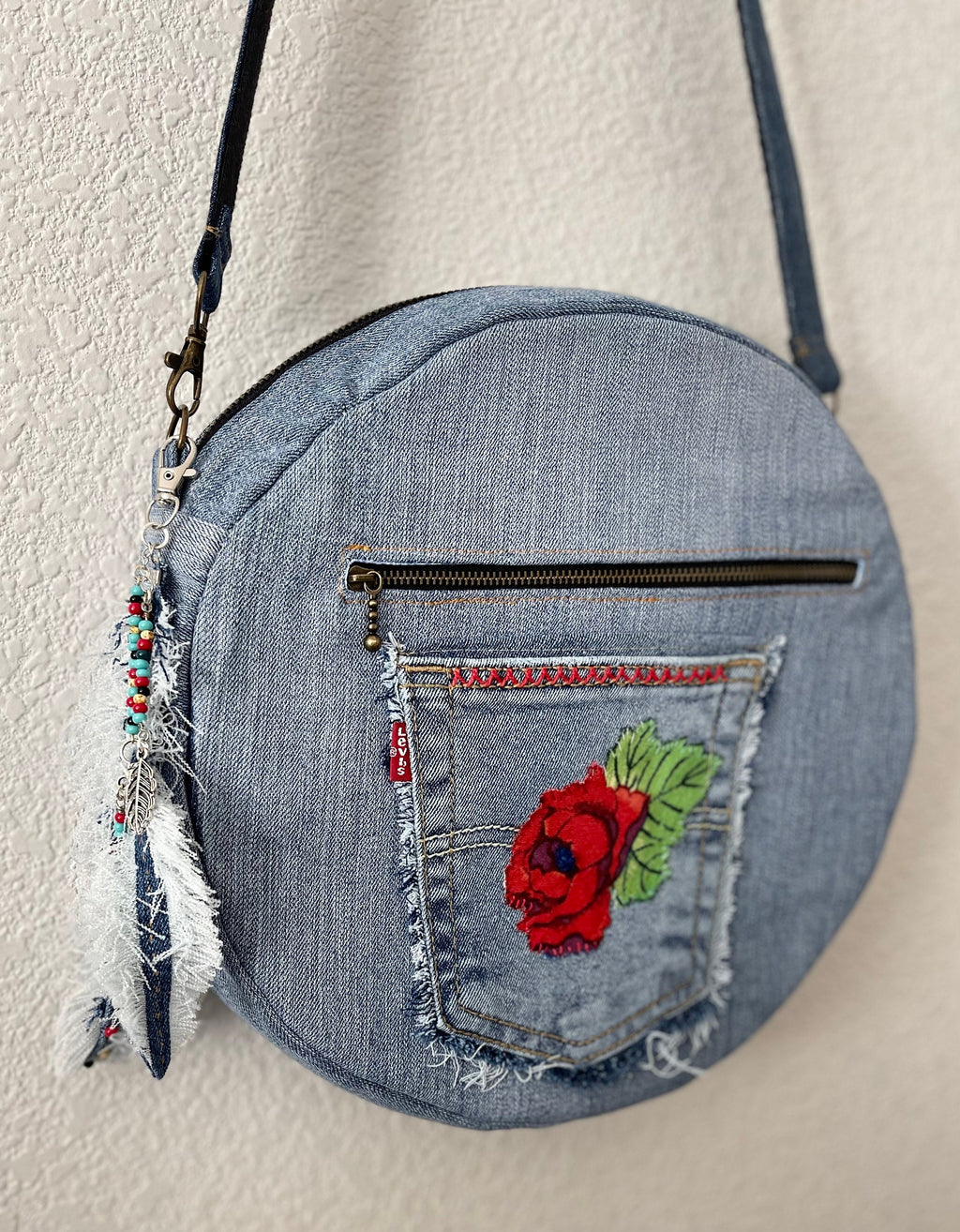 Upcycled denim jeans boho Round Crossbody bag with zipper and pockets.