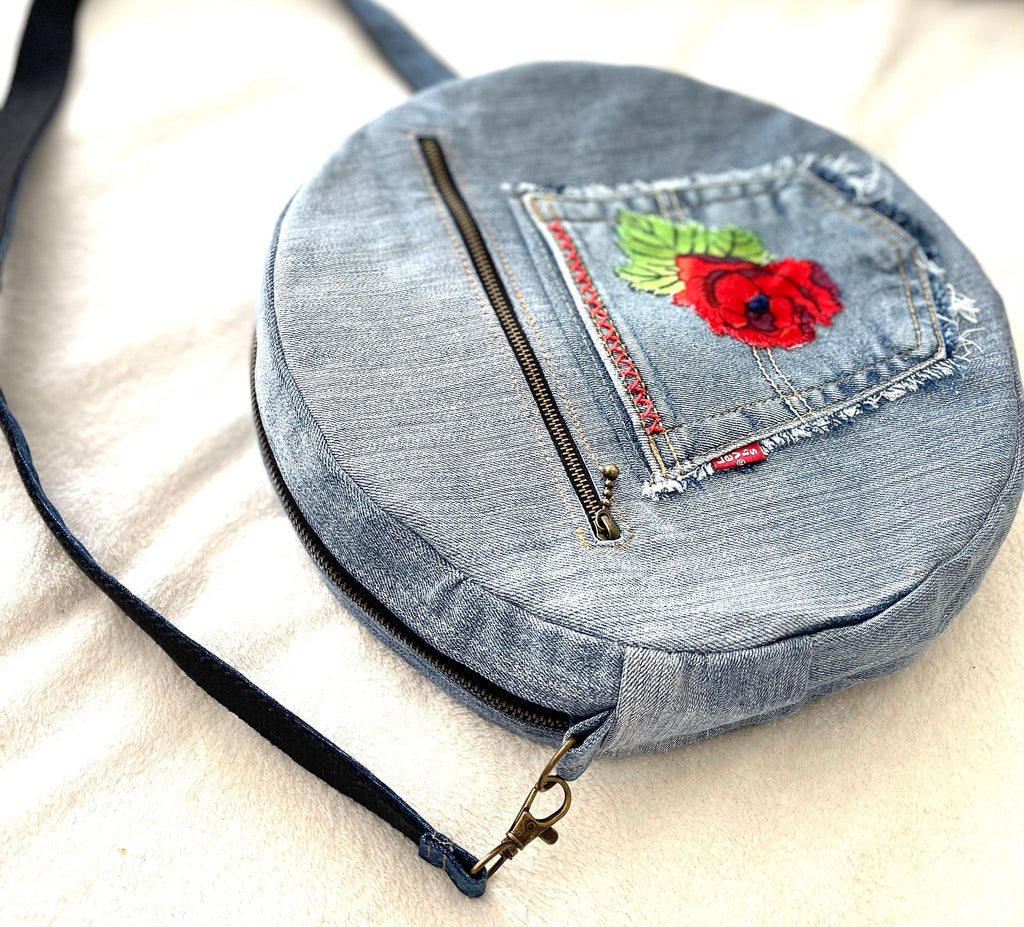 Upcycled denim jeans boho Round Crossbody bag with zipper and pockets.