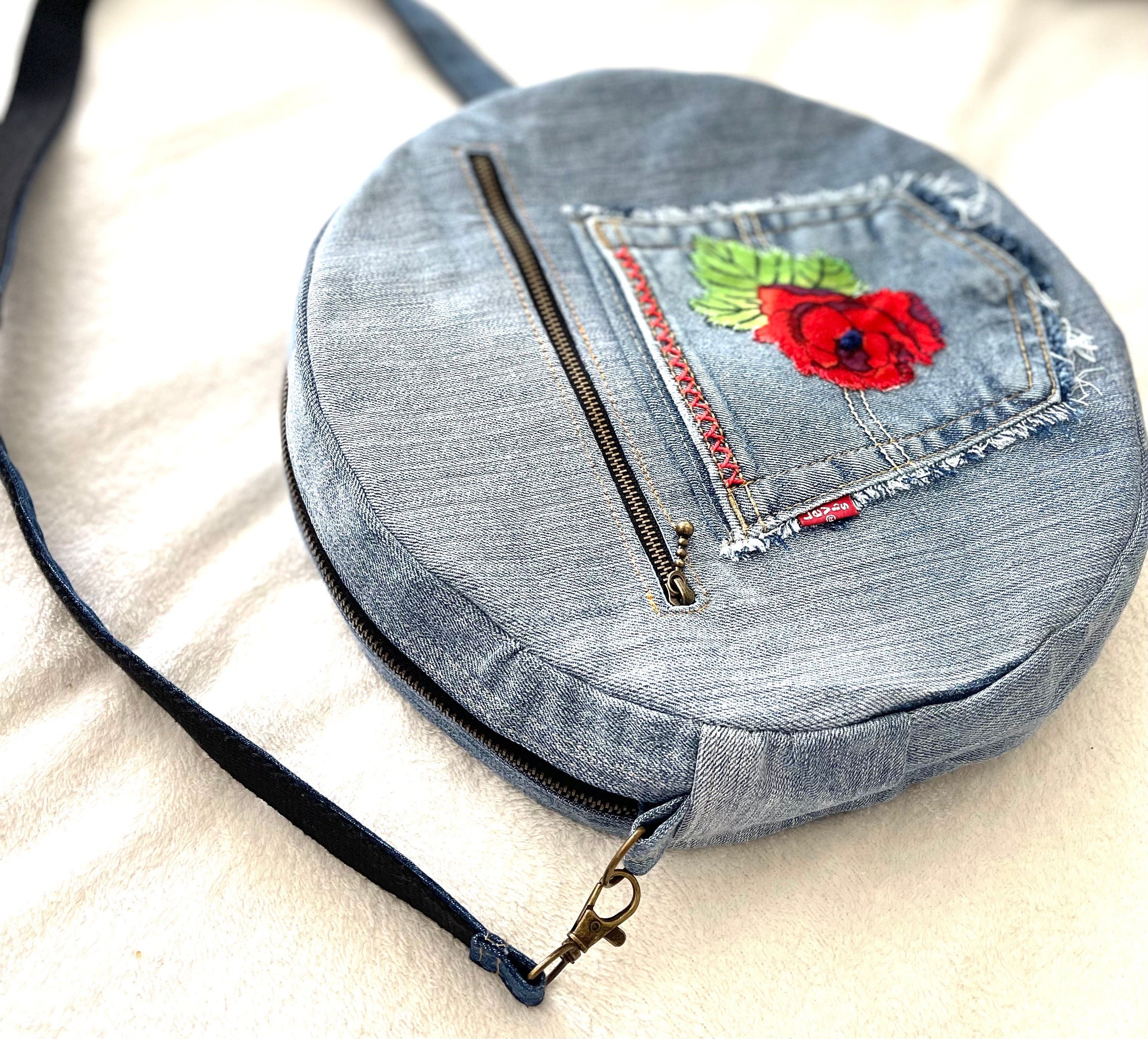 Upcycled denim jeans boho Round Crossbody bag with zipper and pockets.