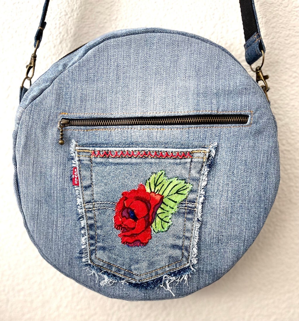 Upcycled denim jeans boho Round Crossbody bag with zipper and pockets.
