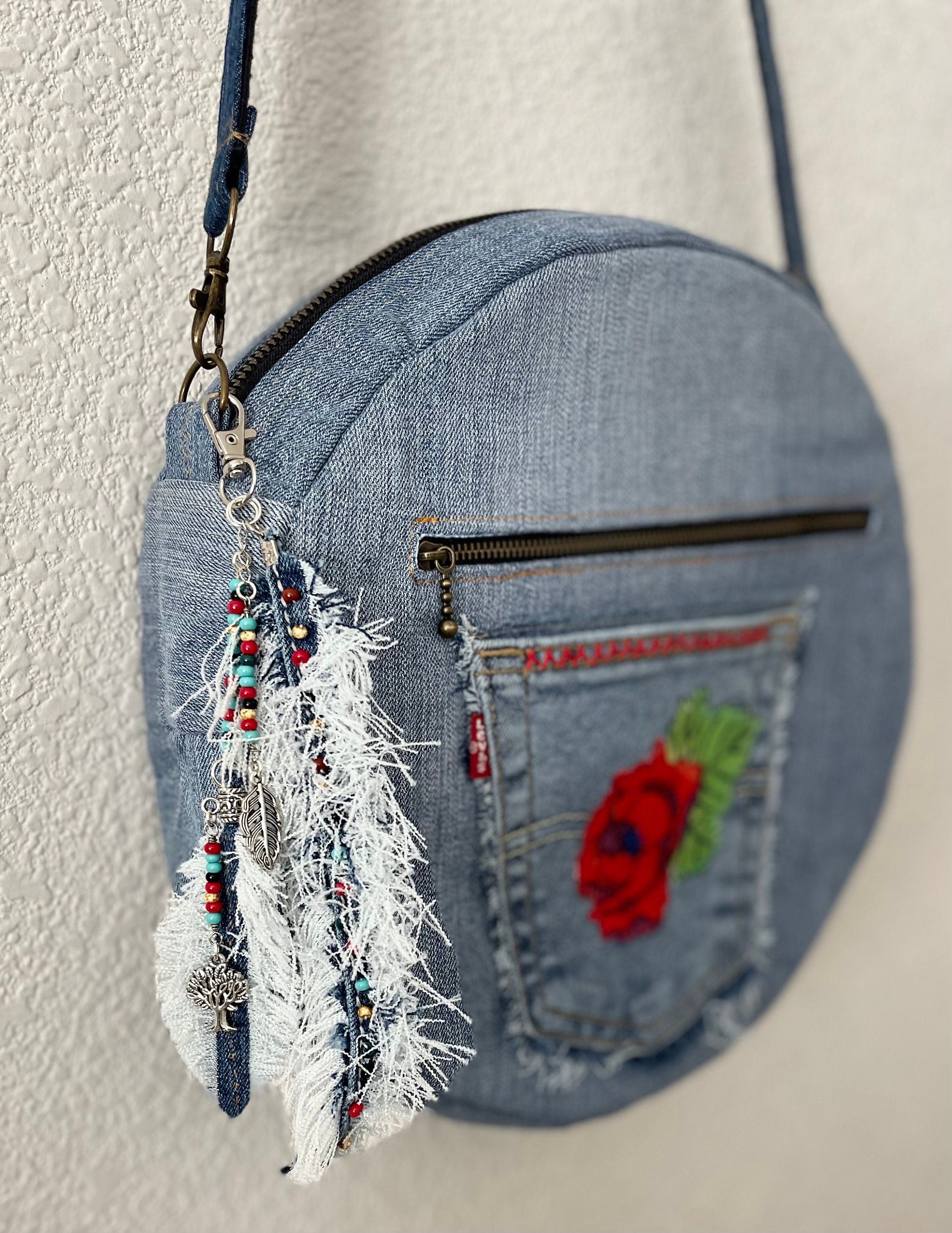 Upcycled denim jeans boho Round Crossbody bag with zipper and pockets.